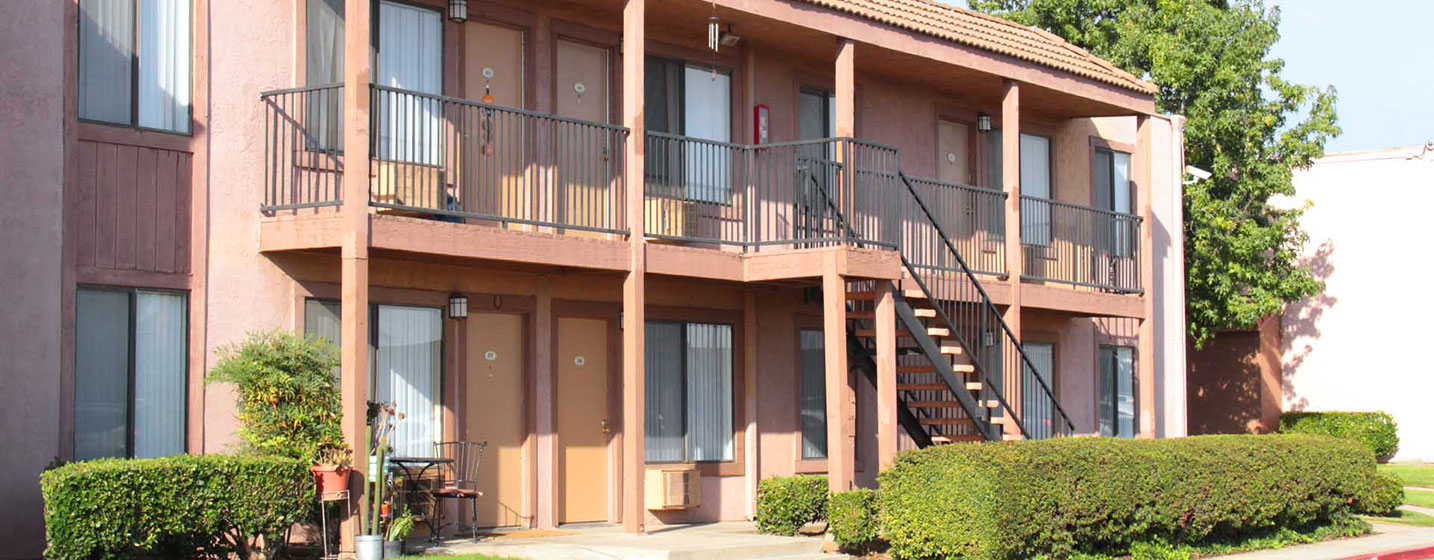 This image shows the exterior of one of the Laurel Palms apartment units